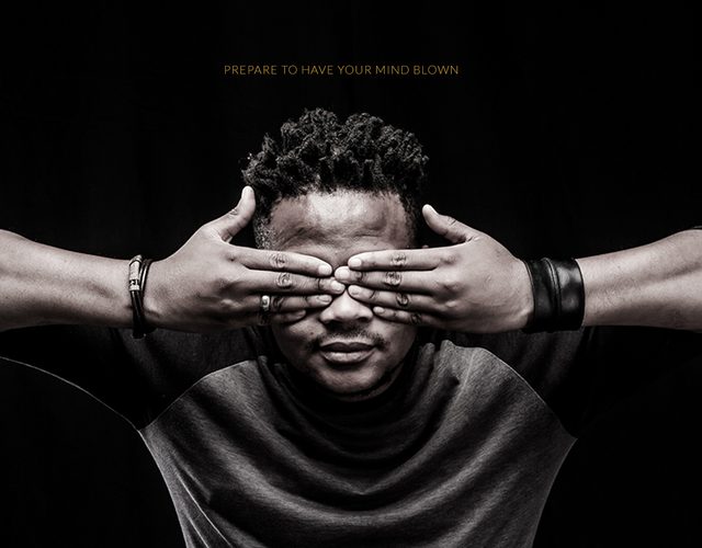 Black and white portrait of a man covering his eyes with his hands