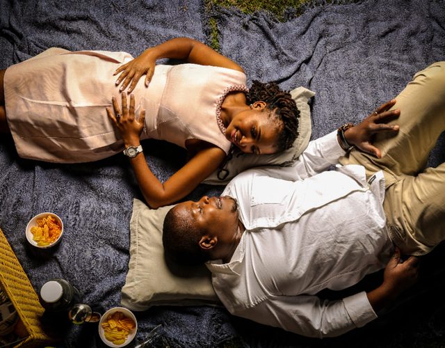 A couple lying on a picnic blanket