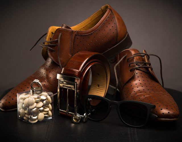 Leather shoes and a belt styled as a product shot