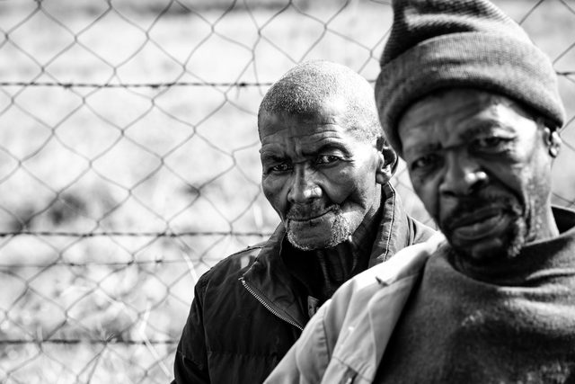 Black and white portrait of two older men side by side
